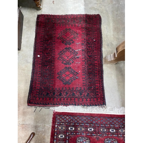 52 - A Bokhara red ground runner and an Afghan rug, larger 250cms x 80cms.