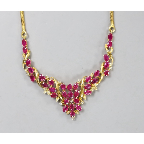 942 - A modern Thai yellow metal, oval cut ruby and diamond chip cluster set necklace, 40cm, gross 22.6 gr... 