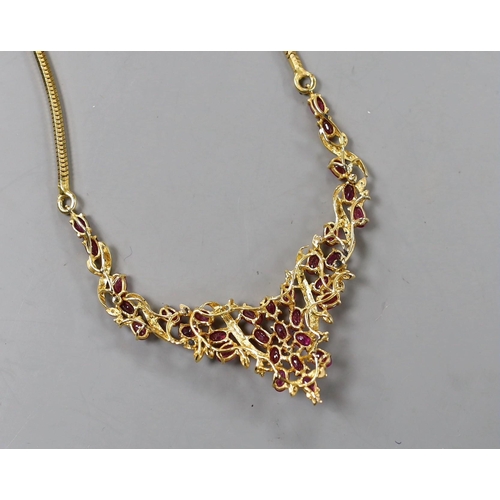 942 - A modern Thai yellow metal, oval cut ruby and diamond chip cluster set necklace, 40cm, gross 22.6 gr... 