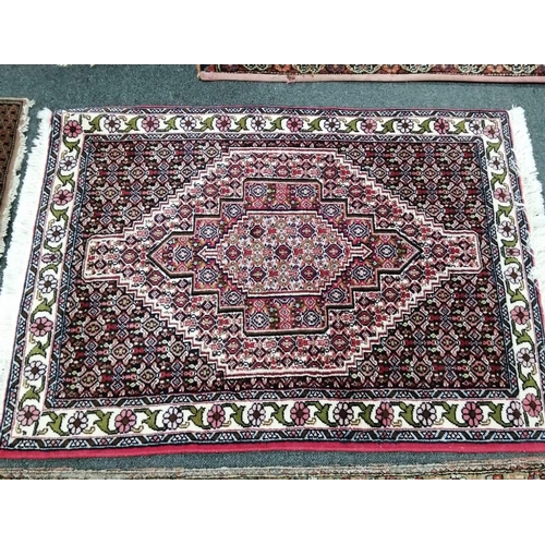 96 - A North West Persian red ground rug, a Tabriz blue ground rug and two smaller modern rugs, largest 2... 