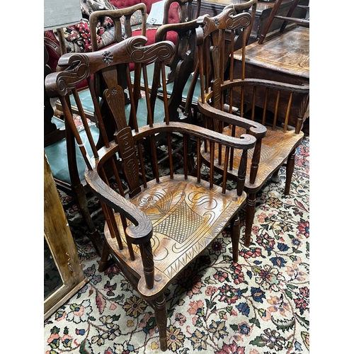 1010 - A pair of carved elm Windsor armchairs, width 69cm, depth 45cm, height 107cm