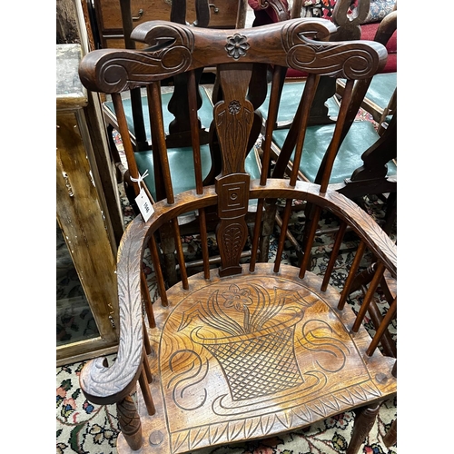 1010 - A pair of carved elm Windsor armchairs, width 69cm, depth 45cm, height 107cm