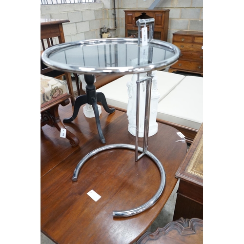 1020 - In the style of Eileen Gray - An E 1027 style circular chrome and smoked glass telescopic occasional... 