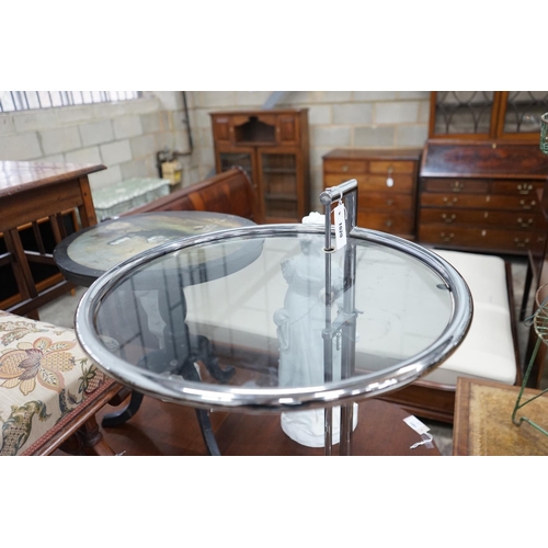 1020 - In the style of Eileen Gray - An E 1027 style circular chrome and smoked glass telescopic occasional... 