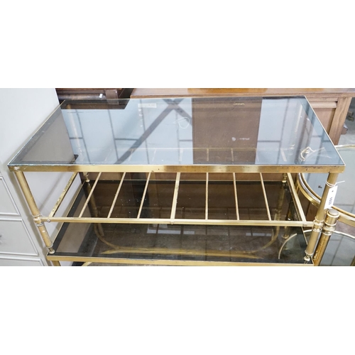 1033 - A brass and smoked glass two tier rectangular coffee table, width 99cm, depth 51cm, height 41cm... 