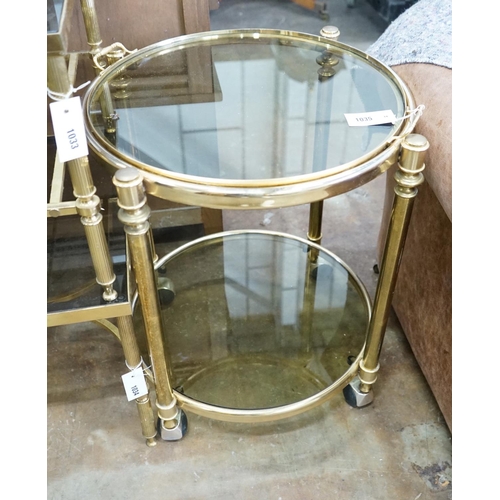 1035 - A circular smoked glass and brass tray top two tier occasional table, diameter 57cm, height 64cm... 