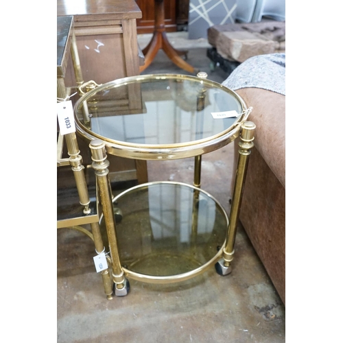 1035 - A circular smoked glass and brass tray top two tier occasional table, diameter 57cm, height 64cm... 