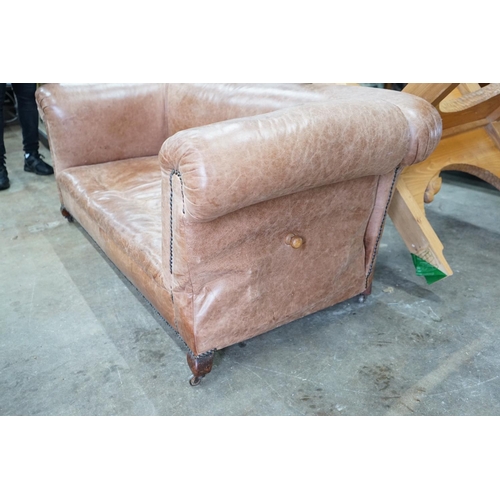 1036 - An early 20th century tan leather drop arm Chesterfield settee, width 160cms, depth 84cms, height 69... 