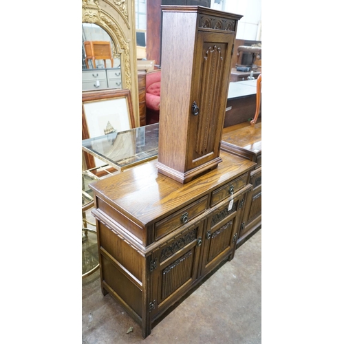 1038 - A reproduction 18th century style carved and linen fold moulded oak side cabinet and matching media ... 