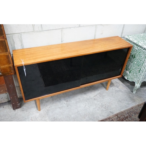 1054 - Robin Day for Hille, a teak and black glass sliding door side cabinet, width 137cms, depth 30cms hei... 