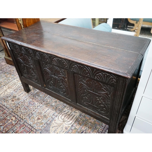 1066 - An 18th century carved, panelled oak coffer, width 130cm, depth 57cm, height 78cm