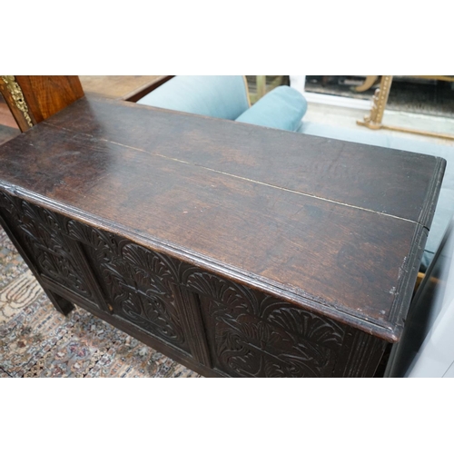 1066 - An 18th century carved, panelled oak coffer, width 130cm, depth 57cm, height 78cm