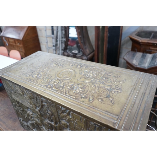 1070 - A Dutch style brass repousse log box, width 79cms, depth 35cms, height 57cms.