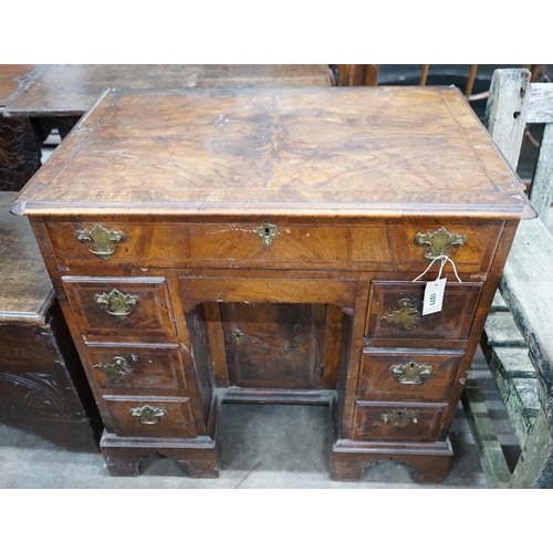 1071 - An 18th century feather banded walnut kneehole desk, width 81cms, depth 52cms, height 76cms.