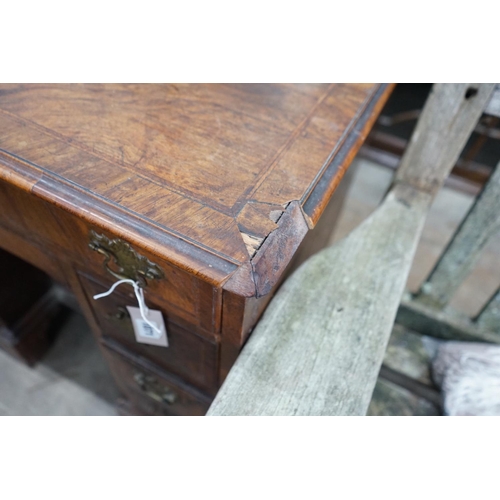 1071 - An 18th century feather banded walnut kneehole desk, width 81cms, depth 52cms, height 76cms.