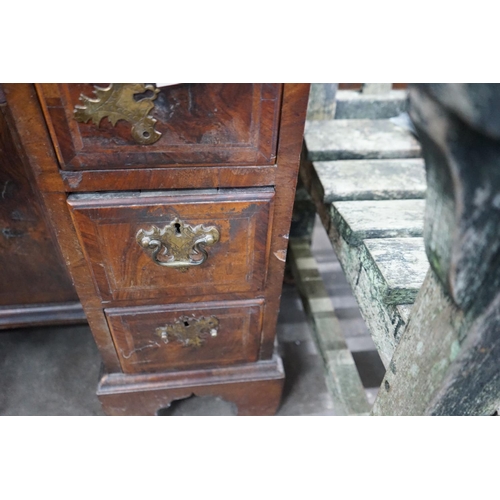 1071 - An 18th century feather banded walnut kneehole desk, width 81cms, depth 52cms, height 76cms.