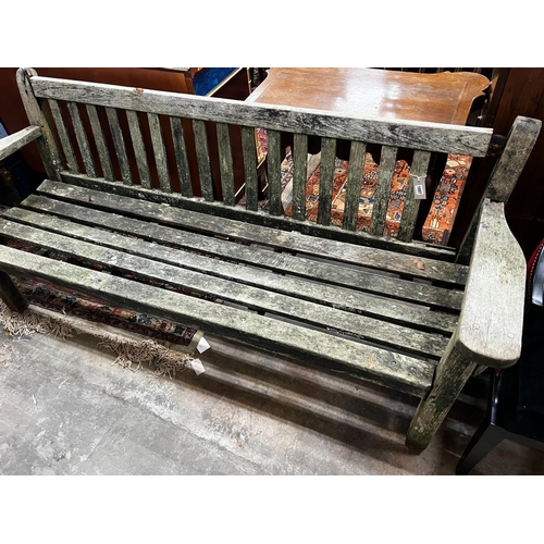 1072 - A weathered teak garden bench, length 194cm, height 83cm (a.f.)