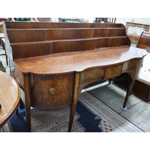 1079 - A George IV mahogany serpentine sideboard, width 214cms, depth 86cms, height 132cms.