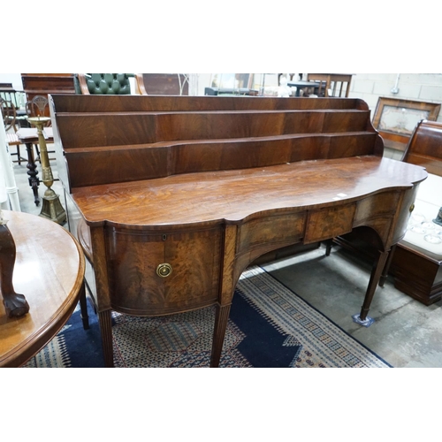 1079 - A George IV mahogany serpentine sideboard, width 214cms, depth 86cms, height 132cms.