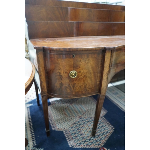 1079 - A George IV mahogany serpentine sideboard, width 214cms, depth 86cms, height 132cms.