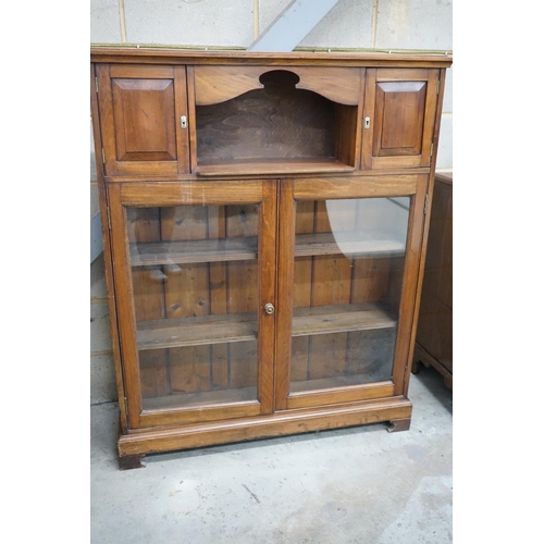 1081 - A Victorian style glazed walnut bookcase width 110cms, depth 26cms, height 136cms.