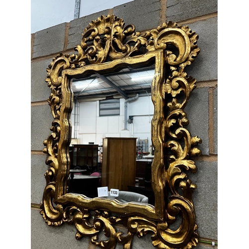 1091 - A rectangular Florentine style scrolling carved gilt framed wall mirror, width 63cm, height 90cm... 