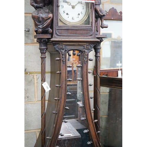 1093 - An early 20th century Flemish carved oak and walnut longcase clock, height 240cms.