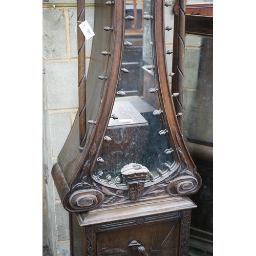 1093 - An early 20th century Flemish carved oak and walnut longcase clock, height 240cms.