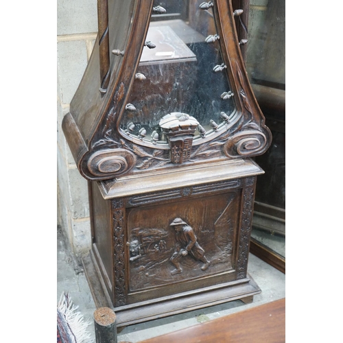 1093 - An early 20th century Flemish carved oak and walnut longcase clock, height 240cms.