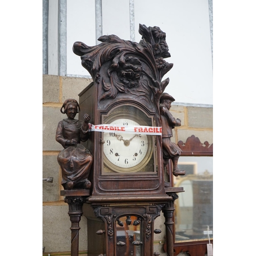 1093 - An early 20th century Flemish carved oak and walnut longcase clock, height 240cms.