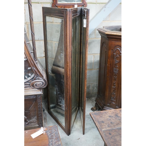 1095 - A late 19th century French mahogany mirrored three fold screen, each panel 53cms x 136cms.