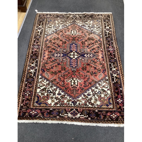 1136 - An Heriz red ground rug 200cms x 148cms