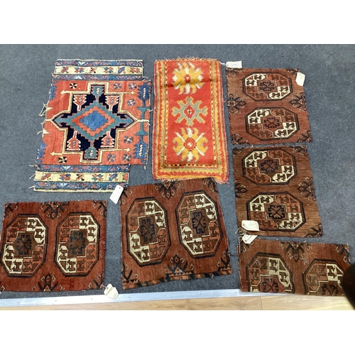 1137 - Five antique Afghan carpet fragments, a Caucasian fragment and a Turkish mat, largest 86cms x 58cms.... 