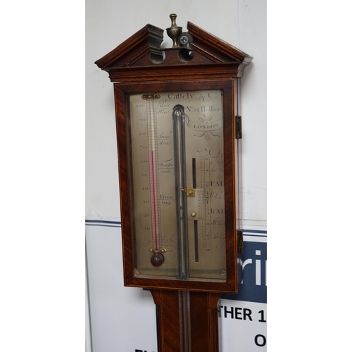 1140 - Cattely & Co, Holborn, London. A George III feathered walnut stick barometer, height 98cms. with bon... 