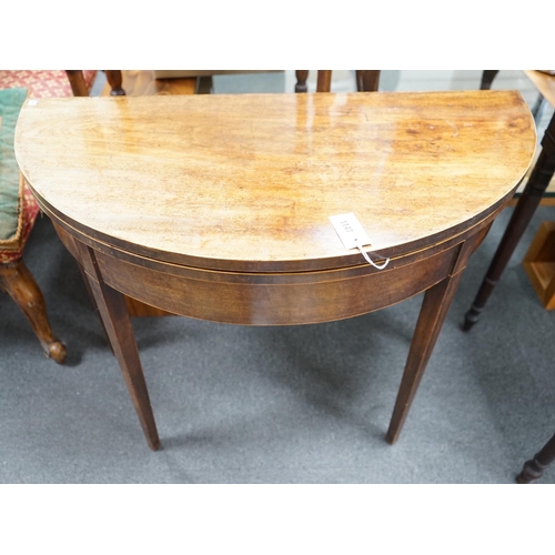 1147 - A George III mahogany and boxwood strung D shaped folding card table, width 91cm, depth 45cm, height... 