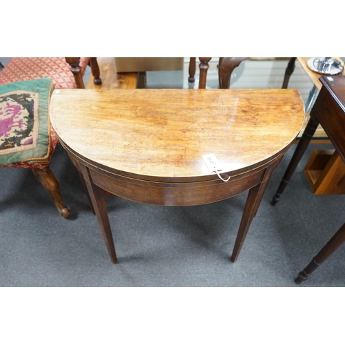 1147 - A George III mahogany and boxwood strung D shaped folding card table, width 91cm, depth 45cm, height... 