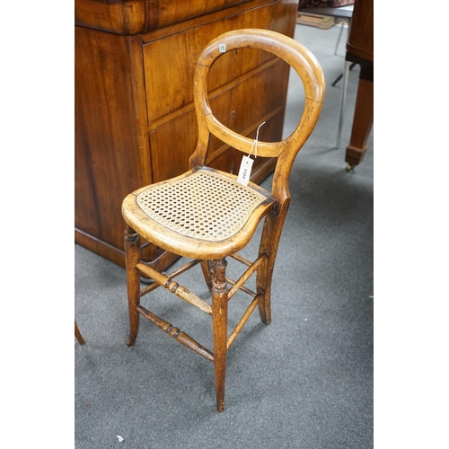 1154 - A Victorian caned beech child's correction chair and an Edwardian inlaid mahogany oval occasional ta... 