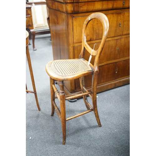 1154 - A Victorian caned beech child's correction chair and an Edwardian inlaid mahogany oval occasional ta... 