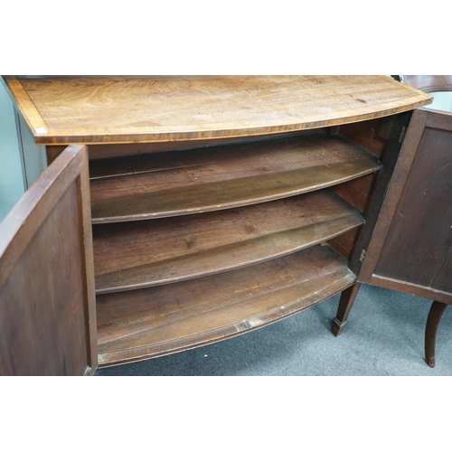 1157 - A George III mahogany and banded bowfront side cabinet with panelled doors on square tapering legs, ... 