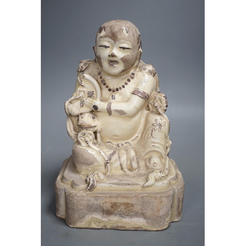 1255 - A Chinese Cizhou seated figure of Liu Hai, possibly Ming dynasty, 21cms high, glaze flaking