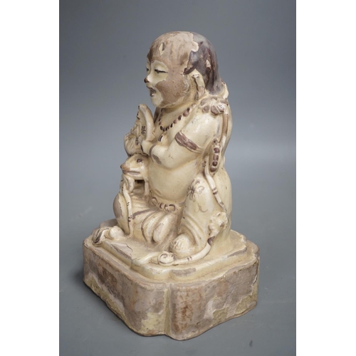 1255 - A Chinese Cizhou seated figure of Liu Hai, possibly Ming dynasty, 21cms high, glaze flaking