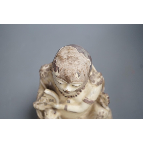 1255 - A Chinese Cizhou seated figure of Liu Hai, possibly Ming dynasty, 21cms high, glaze flaking