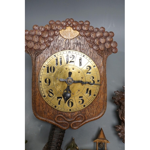 1261 - An early 20th century German Jugendstil oak wall timepiece, four miniature Black Forest timepieces a... 