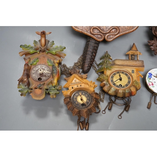 1261 - An early 20th century German Jugendstil oak wall timepiece, four miniature Black Forest timepieces a... 