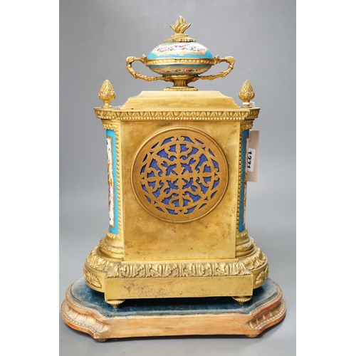 1271 - A French ormolu mantel clock, with inset floral decorated porcelain plaques and dial, 40cms high... 