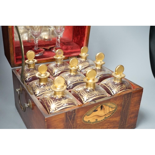 1308 - A 19th century Dutch inlaid mahogany decanter box containing nine gilt glass decanters and two glass... 