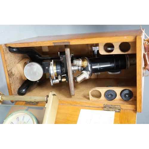 1311 - An oak-cased black japanned microscope, case 35cm high, width 16cm, 20cm depth and a brass mantel ti... 