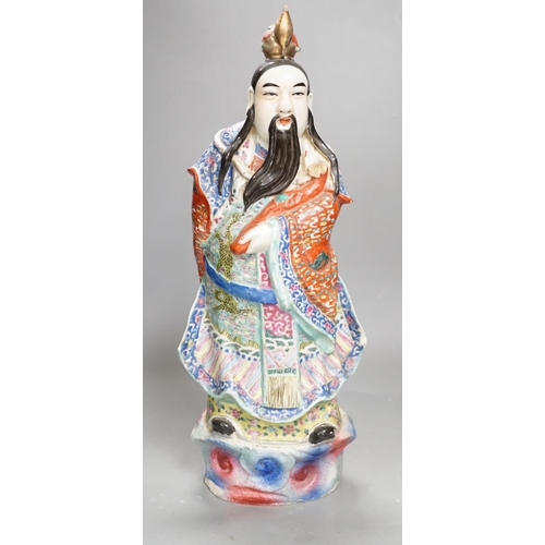 1327 - A Chinese enamelled porcelain figure of an immortal, early 20th century, 43cm