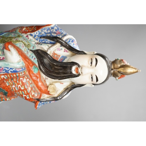 1327 - A Chinese enamelled porcelain figure of an immortal, early 20th century, 43cm