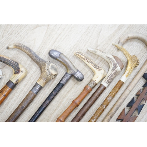 1330 - Twelve assorted walking sticks including silver mounted and staghorn handled